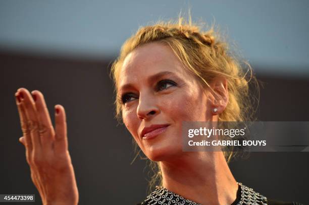 Actress Uma Thurman signs autographs as she arrives for the screening of the movie "Nymphomaniac Volume II director's cut" presented out of...