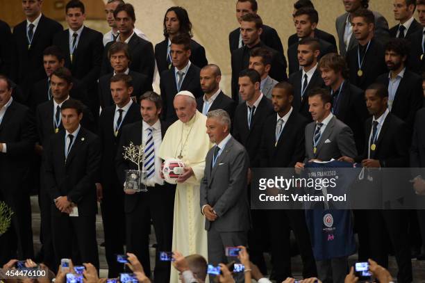 Pope Francis takes a family photo with the players of the 'Partita Interreligiosa Della Pace' at Paul VI Hall on September 1, 2014 in Vatican City,...