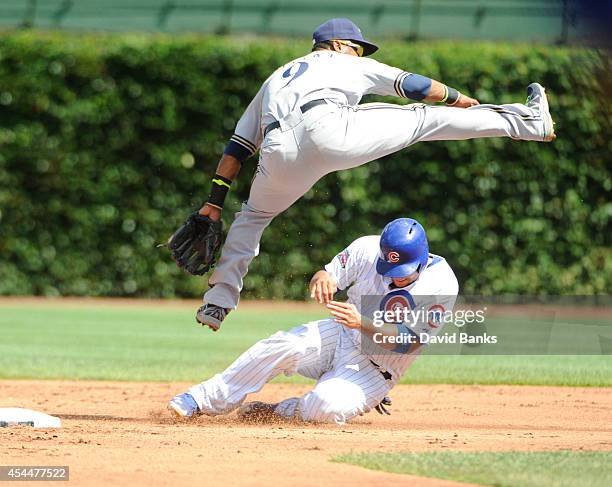 Jean Segura of the Milwaukee Brewers forces out Welington Castillo of the Chicago Cubs during the second inning on September 1, 2014 at Wrigley Field...