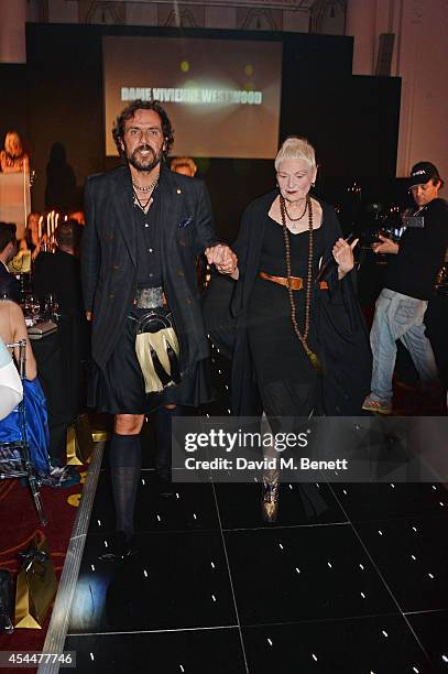 Andreas Kronthaler and Dame Vivienne Westwood walk down the runway after she won the Hall of Fame 2014 award during the Scottish fashion invasion of...