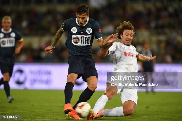 Ricky Alvarez is challenged by Diego Lugano during the Interreligious Match For Peace at Olimpico Stadium on September 1, 2014 in Rome, Italy.