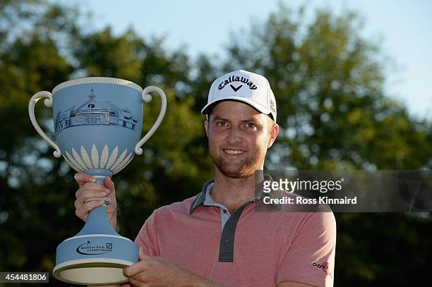 Chris Kirk is presented with the winner's trophy after winning the Deutsche Bank Championship at the TPC Boston on September 1, 2014 in Norton,...