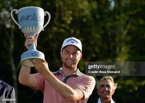 Chris Kirk is presented with the winner's trophy after winning the Deutsche Bank Championship at the TPC Boston on September 1, 2014 in Norton,...