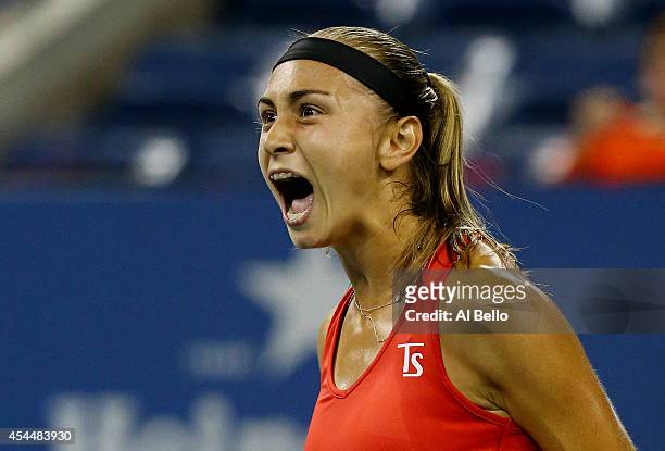 Aleksandra Krunic of Serbia reacts after winning the first set against Victoria Azarenka of Belarus during their women's singles fourth round match...