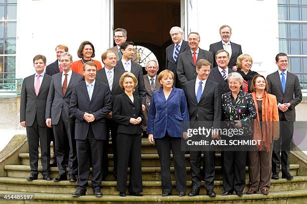 Germany's new cabinet poses for a group photo as they meet for a closed-door cabinet meeting in Meseberg, north of Berlin, on November 17, 2009....