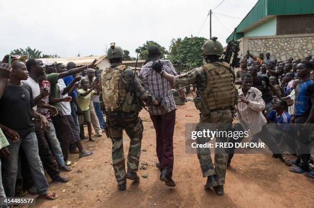 French soldier arrest an alleged ex-seleka rebel in Combattant neighborhood near Bangui's airport, on December 9, 2013. French troops on Monday began...