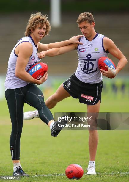 Nathan Fyfe and Tommy Sheridan warm up during a Fremantle Dockers AFL training session at Fremantle Oval on September 2, 2014 in Fremantle, Australia.