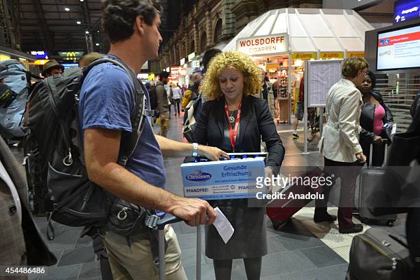 Deutsche Bahn staff distribute water for passengers who wait at Frankfurt am Main Central Station after German rail workers' labour union GDL called...