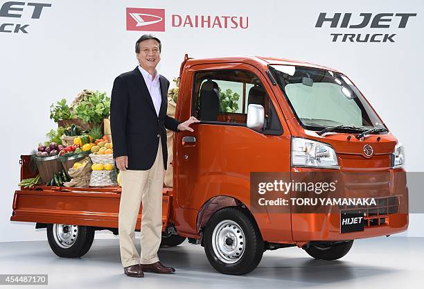 Masanori Mitsui, president of Japan's auto maker Daihatsu, introduces the company's new small business use vehicle 'Hijet Truck' during a press...