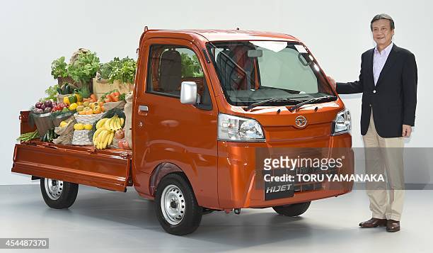 Masanori Mitsui, president of Japan's auto maker Daihatsu, introduces the company's new small business use vehicle 'Hijet Truck' during a press...