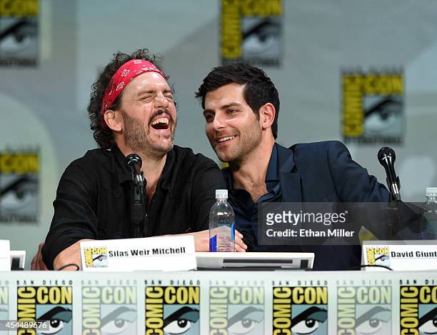 Actors Silas Weir Mitchell and David Giuntoli attend the "Grimm" season four panel during Comic-Con International 2014 at the San Diego Convention...