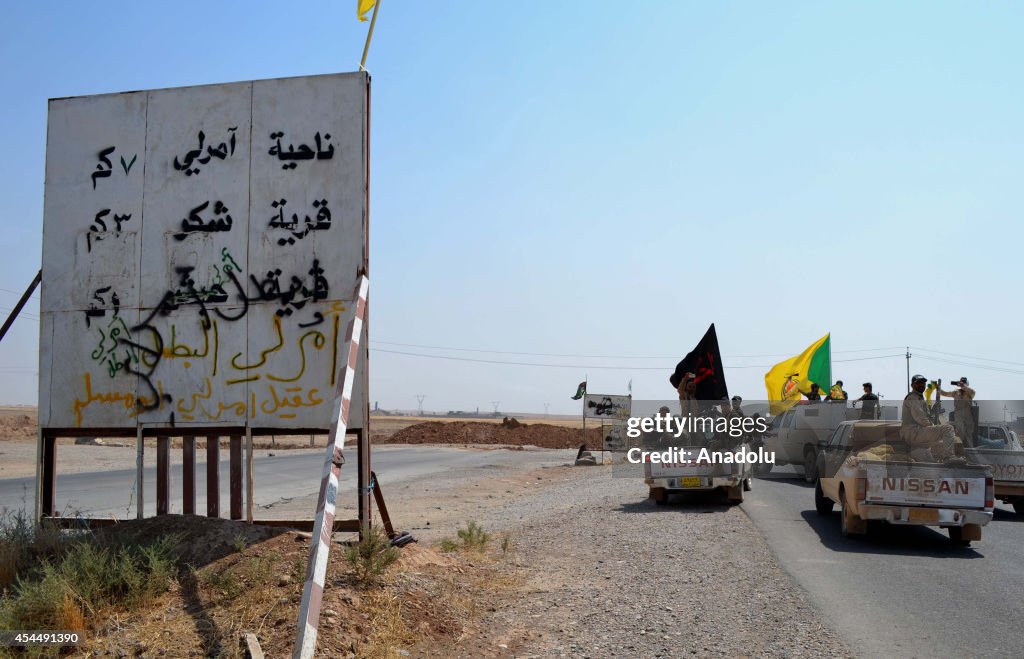 Iraqi forces supported by Kurdish peshmerga and Shiite militias deliver aid to families in Amirli town