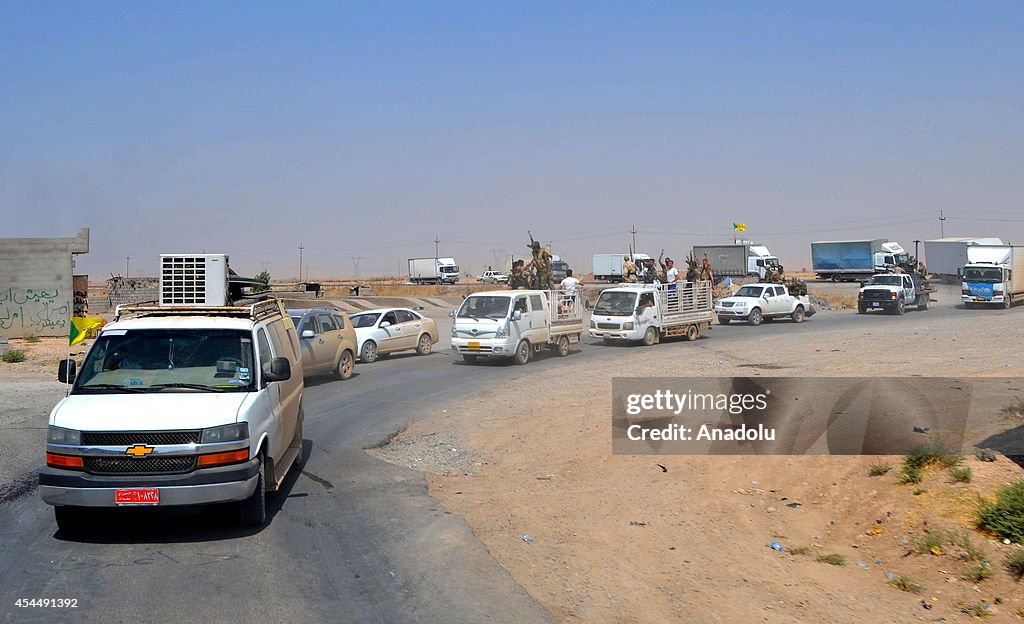 Iraqi forces supported by Kurdish peshmerga and Shiite militias deliver aid to families in Amirli town