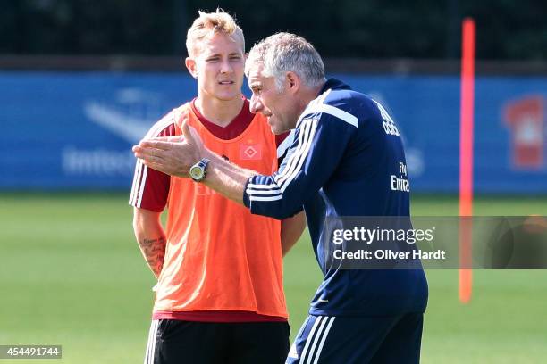 Lewis Holtby and Head coach Mirko Slomka of Hamburg talks during the training session of Hamburger SV on September 2, 2014 in Hamburg, Germany.