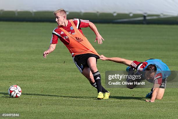 Lewis Holtby and Heiko Westermann of Hamburg compete for the ball during the training session of Hamburger SV on September 2, 2014 in Hamburg,...