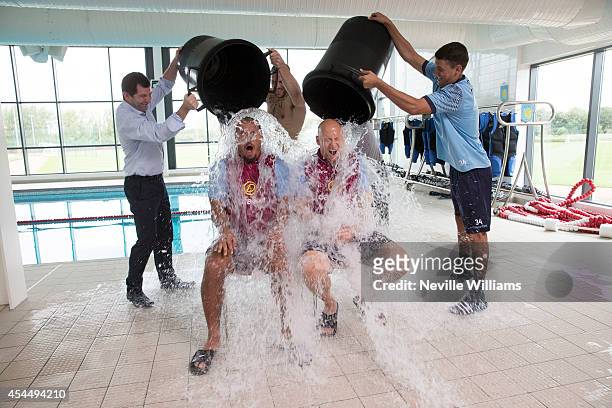 Gabriel Agbonlahor and Brad Guzan of Aston Villa take part in the Ice Bucket Challenge at the club's training ground at Bodymoor Heath on September...