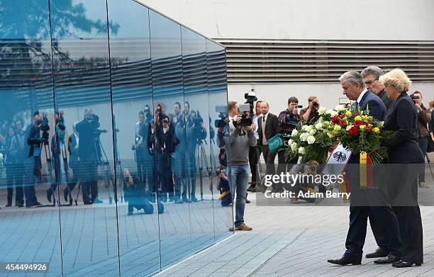 Berlin Mayor Klaus Wowereit and German State Minister Monika Gruetters place flowers on a monument dedicated to the over 200,000 victims of the...