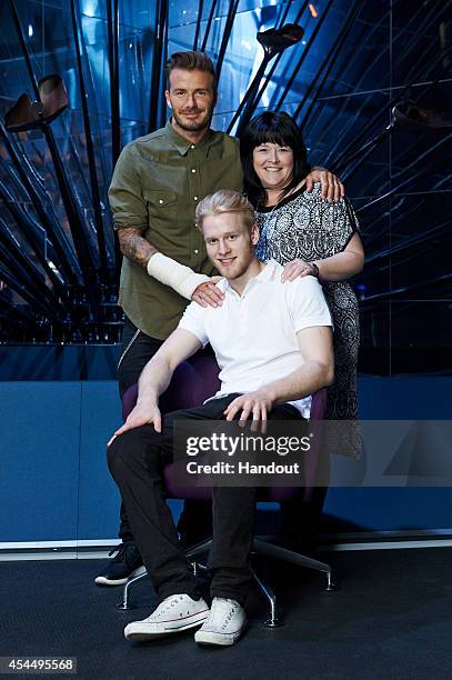 In this handout image supplied by Sainsbury's, Sainsbury's Active Kids ambassadors David Beckham and Jonnie Peacock pose with Jonnie's mother Linda...