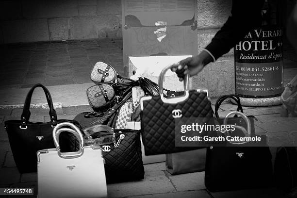 Man sells bags on the street during the 71st Venice Film Festival on September 1, 2014 in Venice, Italy.