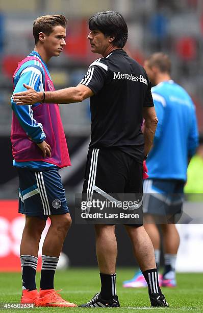 Head coach Joachim Loew speaks with Erik Durm during a Germany training session at Esprit Arena on September 2, 2014 in Duesseldorf, Germany.