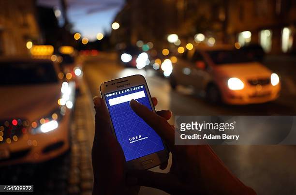 In this photo illustration, a woman uses the Uber app on an Samsung smartphone on September 2, 2014 in Berlin, Germany. Uber, an app that allows...
