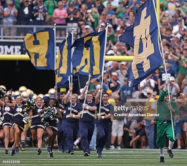The Notre Dame mascot The Leprechan, leads cheerleaders onto the field before a game between of the Notre Dame Fighting Irish and the Rice Owls at...