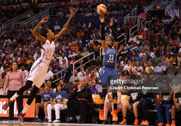 Maya Moore of the Minnesota Lynx puts up a three point shot past DeWanna Bonner of the Phoenix Mercury during the first half of game three of the...