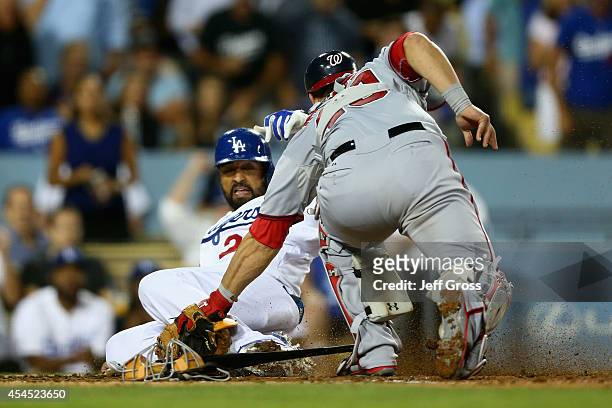 Matt Kemp of the Los Angeles Dodgers is tagged out at home by catcher Wilson Ramos of the Washington Nationals in the fourth inning at Dodger Stadium...