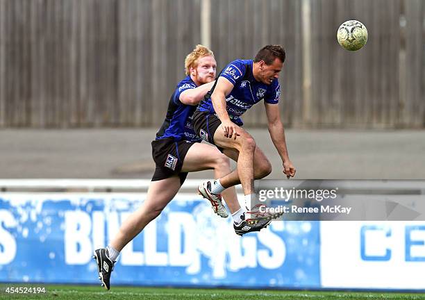 Josh Reynolds gets to the ball ahead of James Graham during a Canterbury Bulldogs NRL training session at Belmore Sports Ground on September 3, 2014...