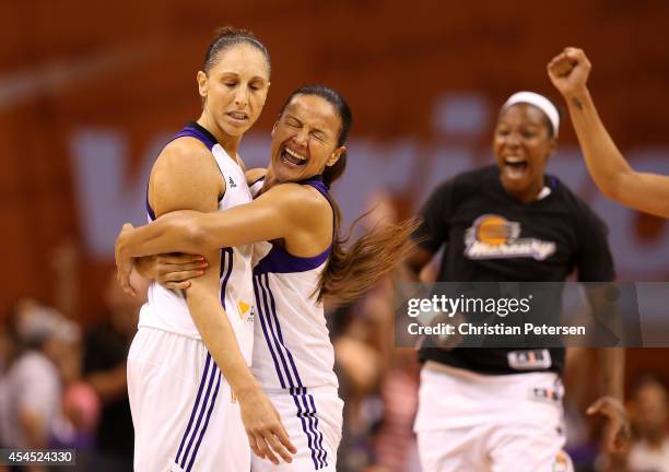 Diana Taurasi of the Phoenix Mercury is congratulated by Mistie Bass after Taurasi hit a half court shot at the end of the third quarter during game...