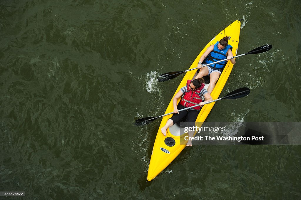 People enjoy the Potomac River on a hot, sticky day as summer winds down