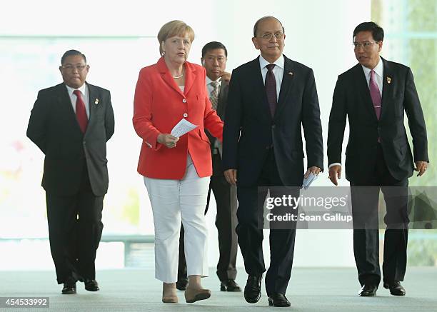 German Chancellor Angela Merkel and Myanmar President Thein Sein arrive to speak to the media following bilateral talks at the Chancellery on...