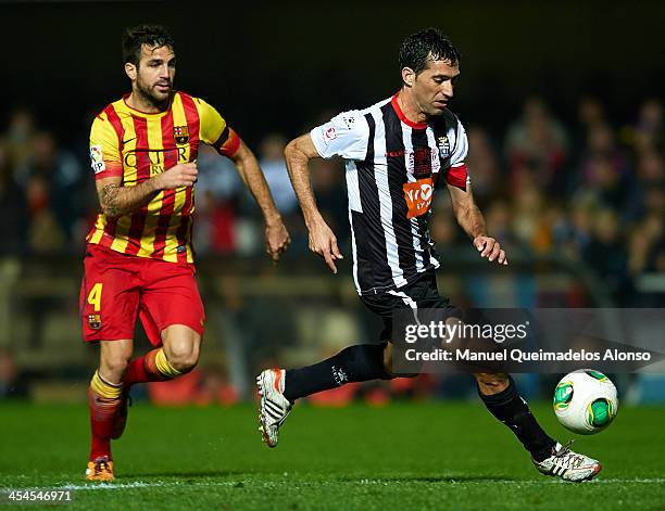 Mariano Sanchez of Cartagena competes for the ball with Cesc Fabregas of Barcelona during the Copa del Rey, Round of 32 match between FC Cartagena...