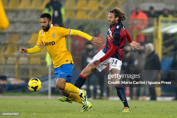 Mirko Vucinic of Juventus competes for the ball with Cesare Natali of Bologna FC during the Serie A match between Bologna FC and Juventus at Stadio...