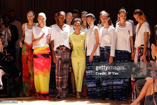 Designer Josie Natori and models acknowledge the audience at the conclusion of the Josie Natori Spring 2015 Collection during Mercedes-Benz Fashion...