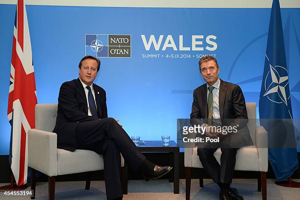 Prime Minister David Cameron and NATO Secretary General Anders Fogh Rasmussen talk on the eve of the NATO Summit 2014 at the Celtic Manor Resort on...
