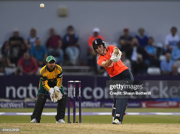 Charlotte Edwards of England plays a shot as South Africa wicket-keeper Trisha Ghetty looks on of South Africa during the NatWest Women's...