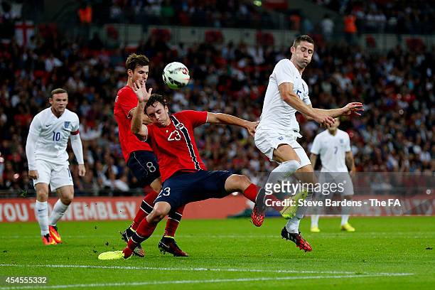 Gary Cahill of England battles for the ball with Vegard Forren of Norway during the International Friendly match between England and Norway at...