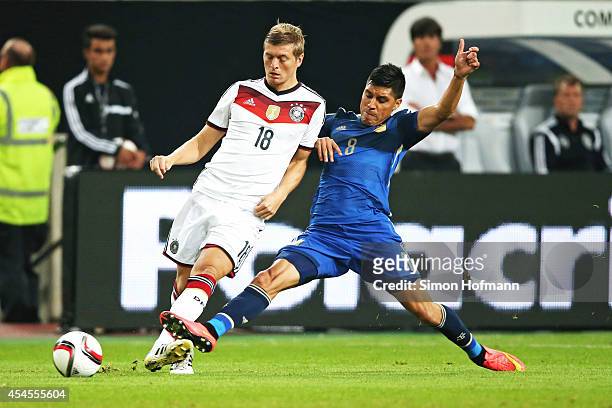 Toni Kroos of Germany is challenged by Enzo Perez of Argentina during the international friendly match between Germany and Argentina at Esprit-Arena...