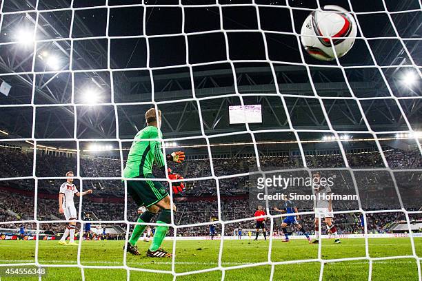 Erik Lamela of Argentina scores his team's second goal against goalkeeper Manuel Neuer of Germany during the international friendly match between...