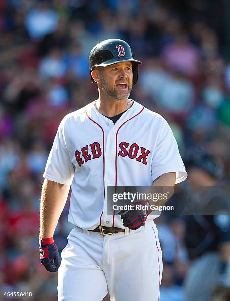 David Ross of the Boston Red Sox argues a called third strike during the eighth inning moments before being ejected against the Seattle Mariners at...