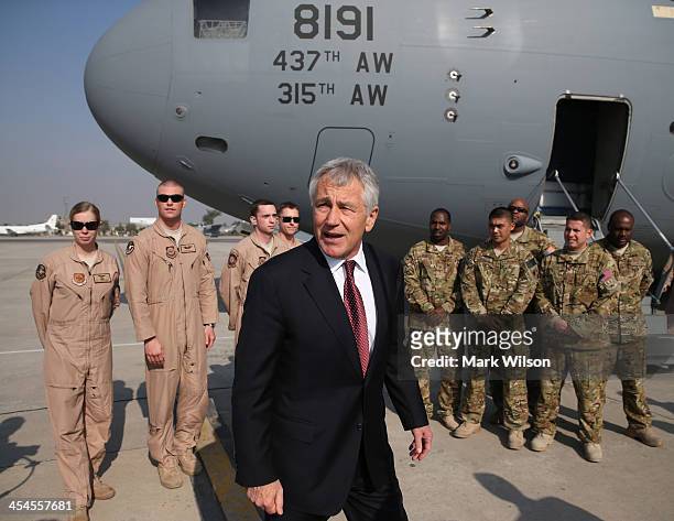 Secretary of Defense Chuck Hagel stands with US troops before departing from the Islamabad International Airport December 9, 2013 at Islamabad,...