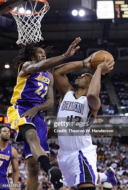 Chuck Hayes of the Sacramento Kings has his shot blocked by Jordan Hill of the Los Angeles Lakers at Sleep Train Arena on December 6, 2013 in...