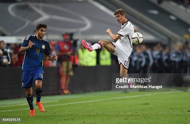September 03: Thomas Mueller of Germany controls the ball against Ricardo Alvarez of Argentina during the international friendly match between...