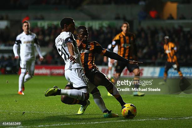 Jonathan de Guzman of Swansea City is challenged by Maynor Figueroa of Hull City during the Barclays Premier League match between Swansea City and...