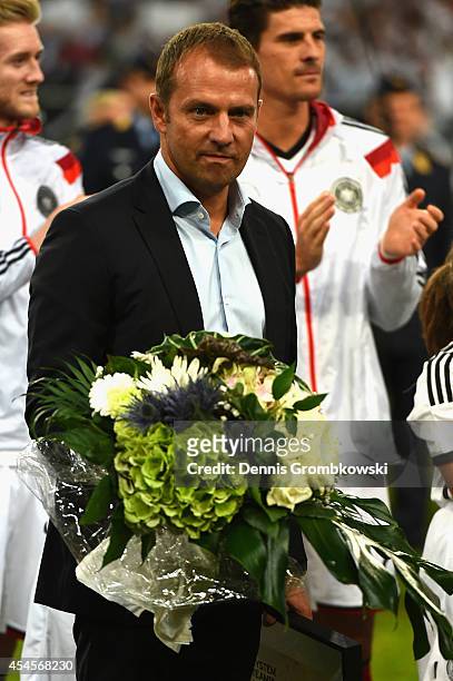Hans-Dieter Flick of Germany is honored after retiring from the German National Team prior to the international friendly match between Germany and...