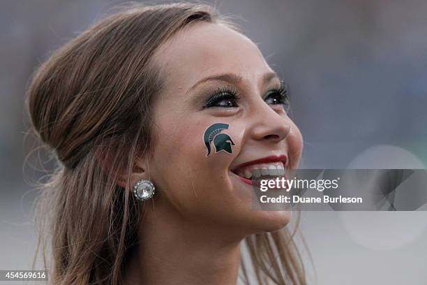 Member of the Michigan State Spartans dance team during their game against the Jacksonville State Gamecocks at Spartan Stadium on August 29, 2014 in...