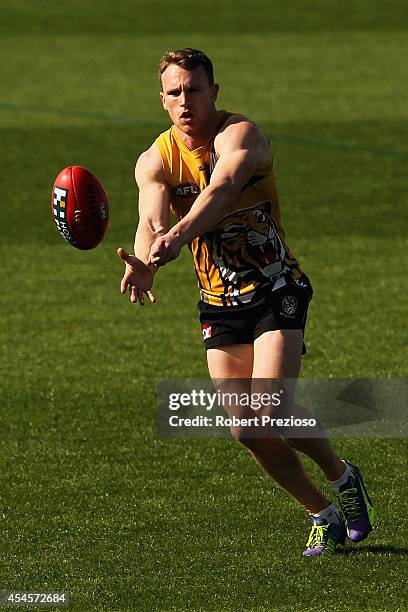 Nathan Foley handballs during a Richmond Tigers AFL media session at ME Bank Centre on September 4, 2014 in Melbourne, Australia.