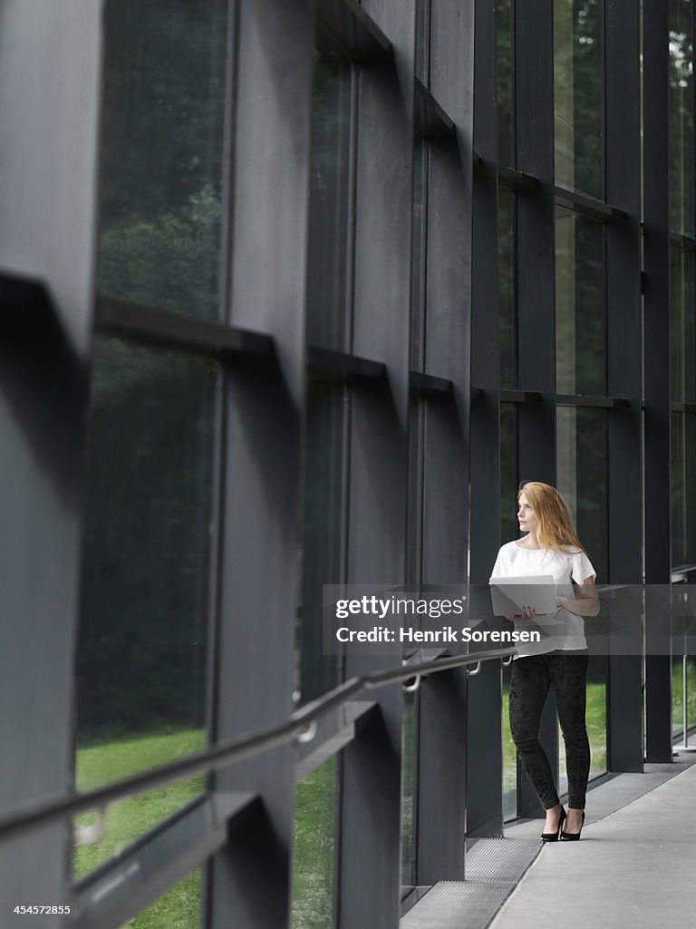 Business woman leaning on railing