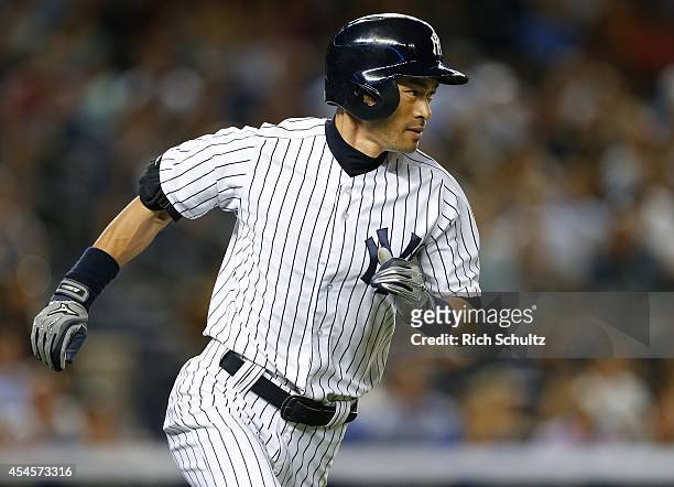 Ichiro Suzuki of the New York Yankees runs to first base on a single in the fifth inning against the Boston Red Sox in a MLB baseball game at Yankee...